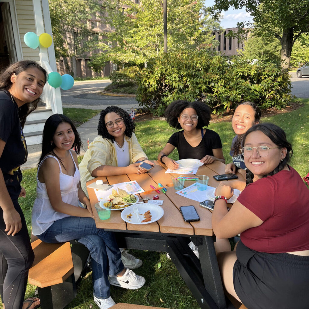 Women of color sitting together for the Afro-Latinidad Celebration